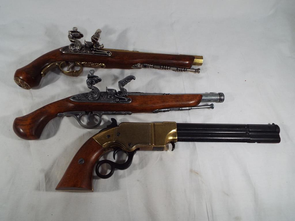 Two Replica Flintlock pistols and a Replica rare Volcanic repeating under lever pistol