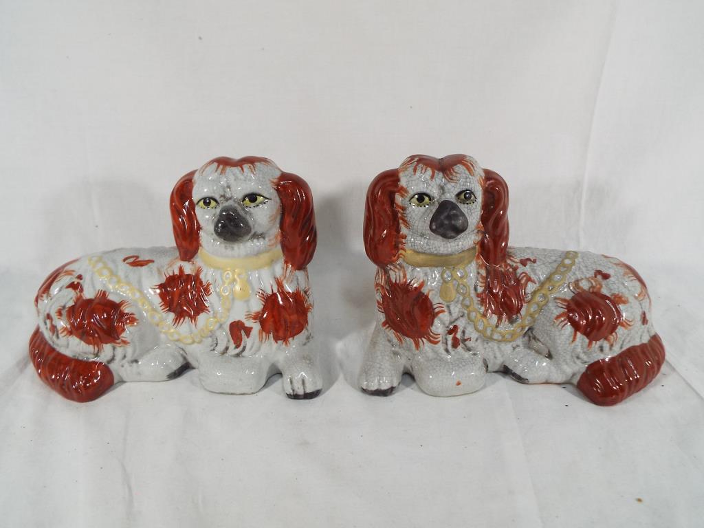 A pair of Staffordshire brown and white dogs Est £15- £25