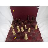 A good quality chess set by Gino Ferrari with carved wooden board approximately 46 cm x 46 cm