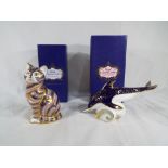 Royal Crown Derby - two paperweights by Royal Crown Derby depicting a dolphin and a cat,