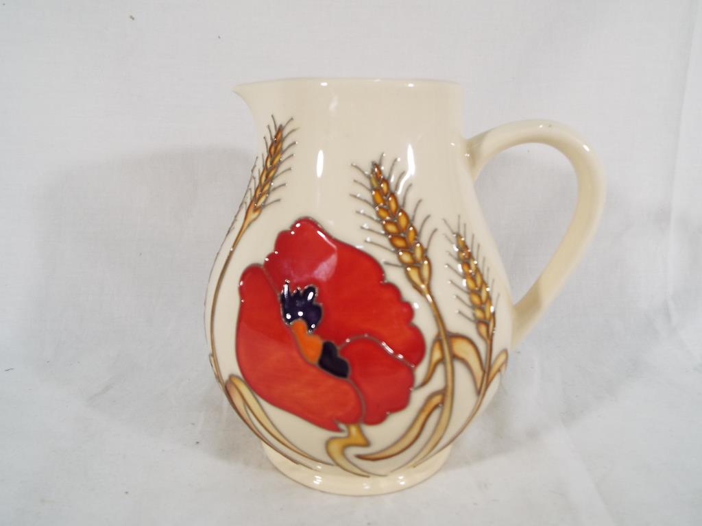 Moorcroft Pottery - a Moorcroft Pottery jug decorated in the Harvest Poppy design, 15.