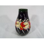 Moorcroft Pottery - a Moorcroft Pottery vase in the Drumming pattern, 12.