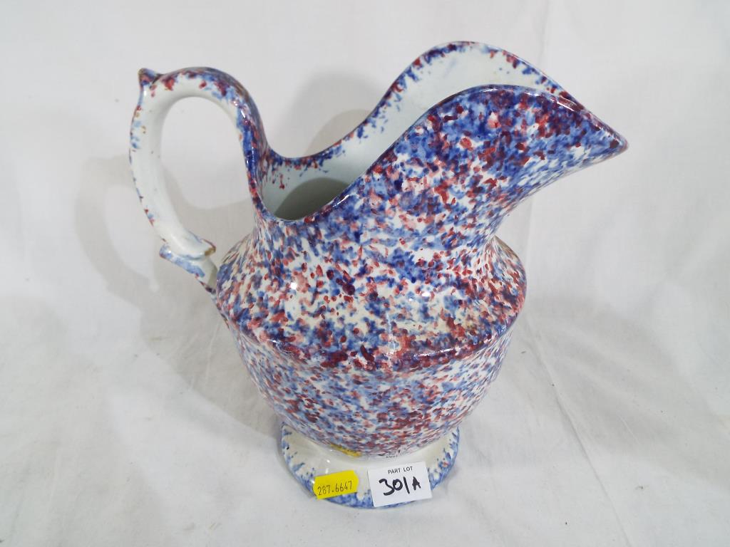 An antique glazed jug, approximately 23 cm (h).