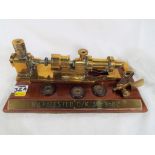 A brass engineering retirement gift on a mahogany plinth inscribed "Wilf tested O/K 30-9-82"