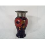 Moorcroft Pottery - a William Moorcroft baluster vase decorated in the Pomegranate pattern with a
