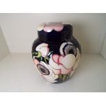 Moorcroft Pottery - a lidded ginger jar decorated with anemone, apprx 15.