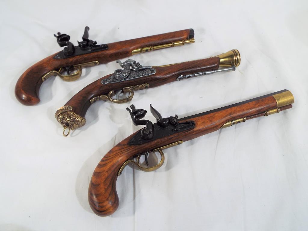 Three replica pistols to include two flintlock and one percussion pistol