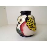 Moorcroft Pottery - a vase decorated with depictions of two Doves,