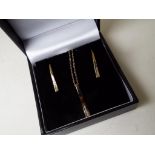 A lady's 9 carat gold .20 pt diamond stick pendant and earrings set, approx. weight 2.