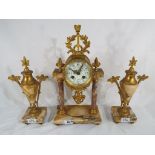 A decorative early 20th century portico styled mantel clock with floral swag decoration and