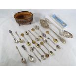 A hallmarked silver pierced pot and a quantity of silver and plated decorative teaspoons and