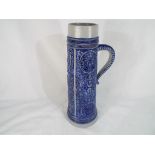 A German stoneware tankard / stein with blue relief decoration, the base impressed 436,