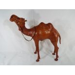 A good quality figurine in the form of a camel made from leather, approximate height 40 cm.