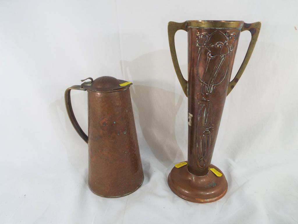 An Arts and Crafts copper embossed two-handled vase,