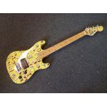 A six string electric guitar, the body decorated in a Spongebob Squarepants by Nickelodeon theme,