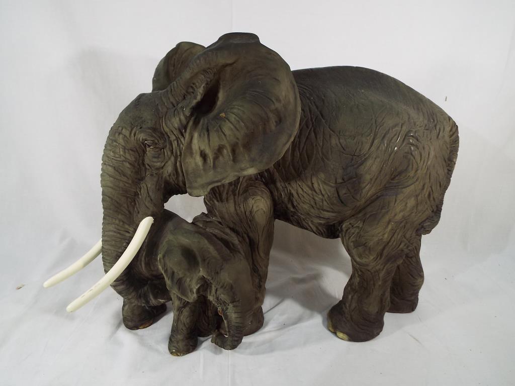 A large ornamental figurine depicting mother and calf elephants