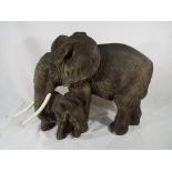 A large ornamental figurine depicting mother and calf elephants