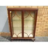 A glass fronted display cabinet 125 cm (h) x 94 cm (w) x 26 cm (d)