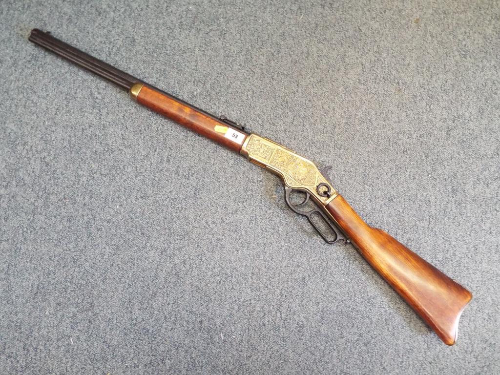 A replica Winchester underlever hunting rifle with ejector cover and hunting scenes