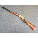 A replica Winchester underlever hunting rifle with ejector cover and hunting scenes