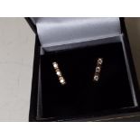 A lady's pair of 9 carat gold 20 pt diamond trilogy stud earrings,