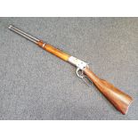 A replica Winchester underlever rifle with moving underlever action