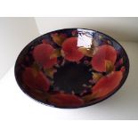 Moorcroft Pottery - a large pedestal bowl decorated with pomegranate on a blue ground,