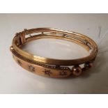 A lady's hallmarked 9 carat gold stone set bangle, approx. weight 16.