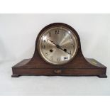 A oak cased mantel clock striking the hour and half hour, German movement marked Haller AG,