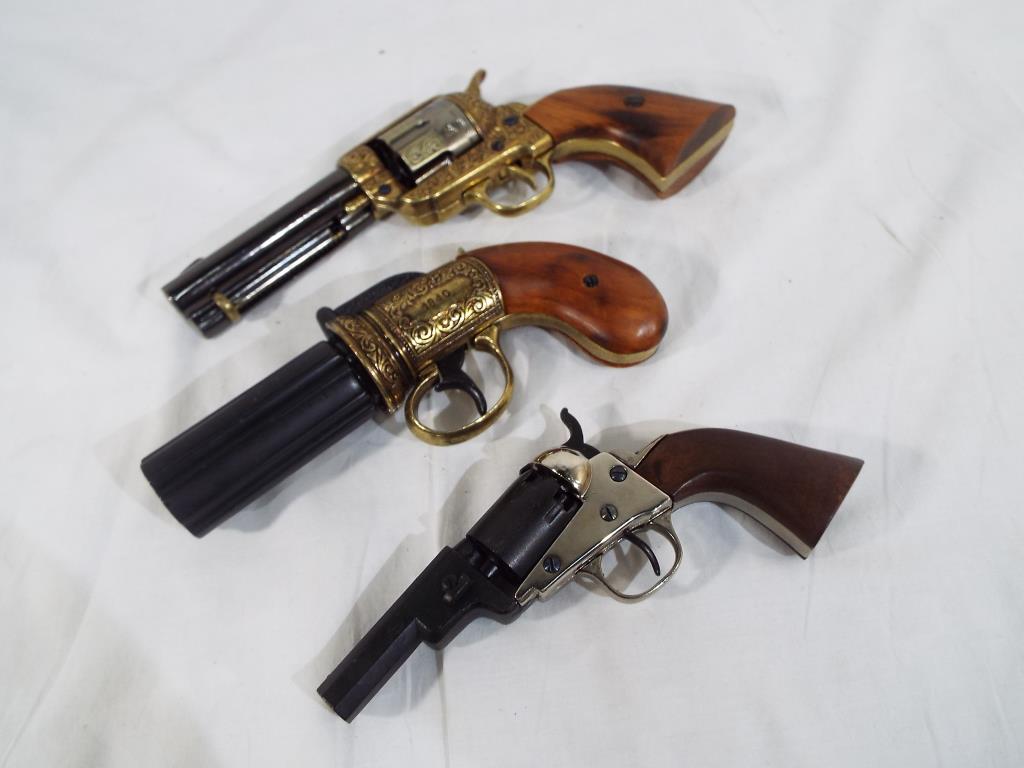 Three replica pistols to include a colt single action percussion pocket pistol also a single action