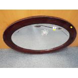 A good quality mahogany bevel edged oval wall mirror, overall height 54 cm x overall width 87 cm.