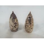 A miniature pair of silver corn shaped cruets stamped sterling 950 to the base,