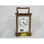 A brass cased carriage timepiece, cylinder escapement, white enamel dial with Roman numerals,