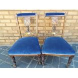 A pair of Edwardian inlaid low chairs.