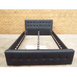 A faux leather double bed complete with slats.