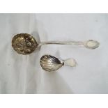 A silver caddy spoon and a silver highly decorated sifter, overall weight 44 grams.