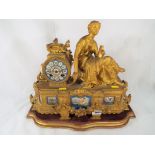 A decorative French spelter mantle clock, 8-day hour and a half past bell strike movement,