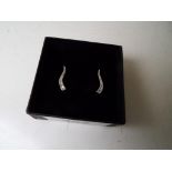 A lady's pair of 9 carat white gold 10 pt diamond set stick earrings, approx weight 1.