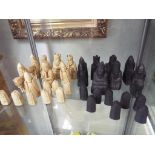 A set of Isle of Lewis chess pieces made from carved saop stone.