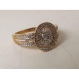 A lady's 9 carat 50 point ½ carat baguette and round diamond ring, approx. 3.