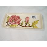 Moorcroft Pottery - a rectangular pen tray decorated with pink magnolia on an ivorine ground, 20.