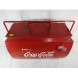 A metal cool box advertising Coca Cola, approximate height 38 cm x 44 cm x 24 cm.