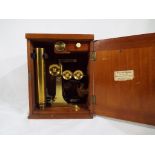 A brass microscope in original wooden box.