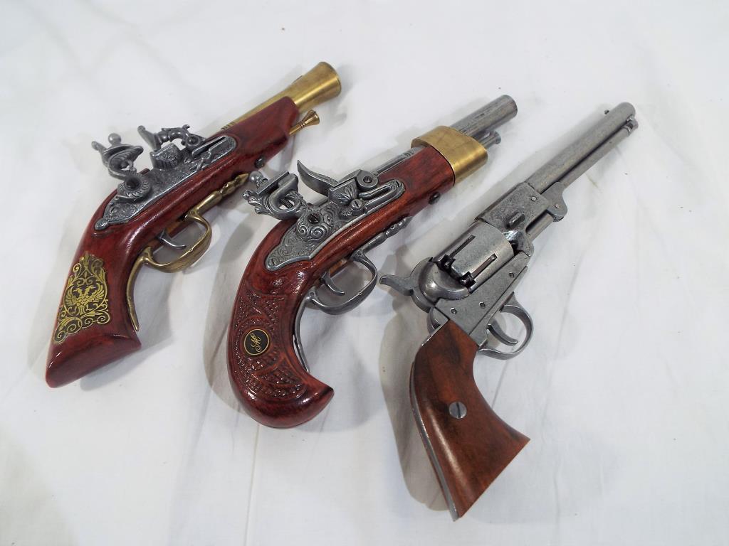 Three replica pistols to include two Spanish flintlocks and a Colt army percussion pistol