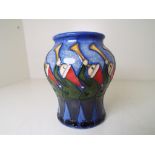 Moorcroft Pottery - a baluster vase decorated with depictions of Eleven Pipers Piping,