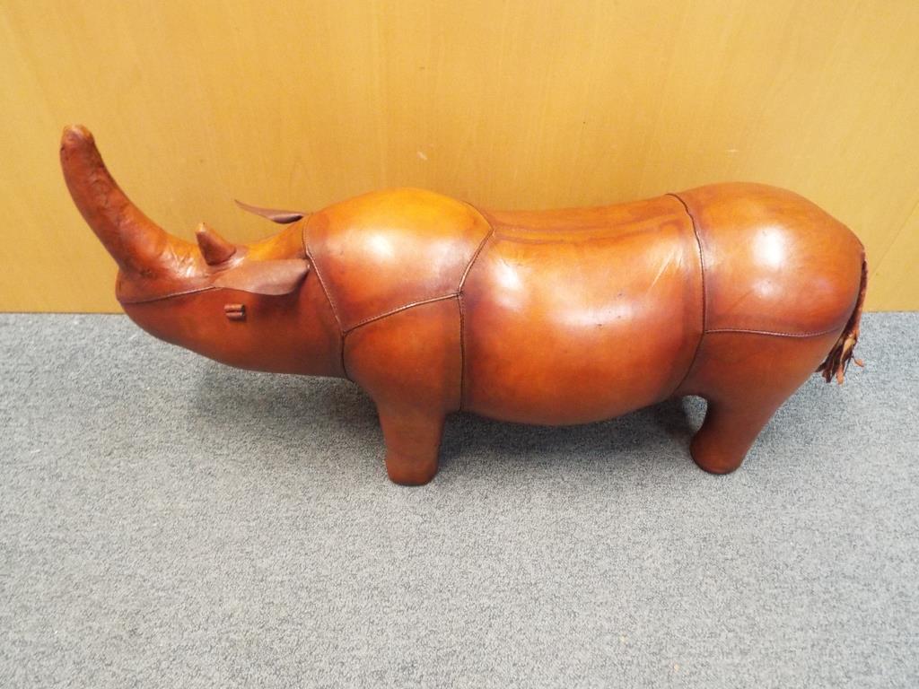 A good quality leather footstool in the form of a rhino, 48 cm x 89 cm.