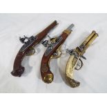 Three replica pistols to include a tri barrel flintlock pistol and two other flintlock pistols