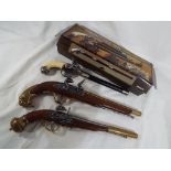 Two replica flintlock duelling pistols and a replica percussion walking cane gun