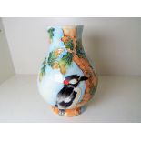 Old Tupton Ware - a baluster vase with slip decoration depicting a woodpecker, approx 15 cm (high),