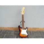 A Fender Squier Strat 6-string electric guitar in tobacco sunburst finish - Estimate £50 to £80